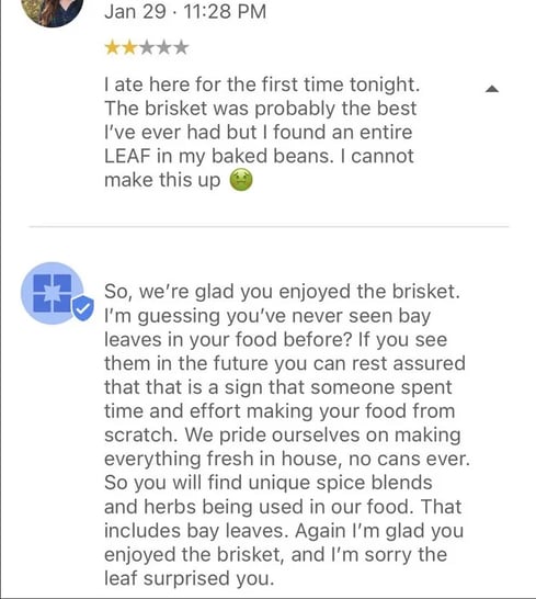 Screenshot of a customer review complaining about a bay leaf in food and a restaurant’s public response explaining ingredients and apologizing