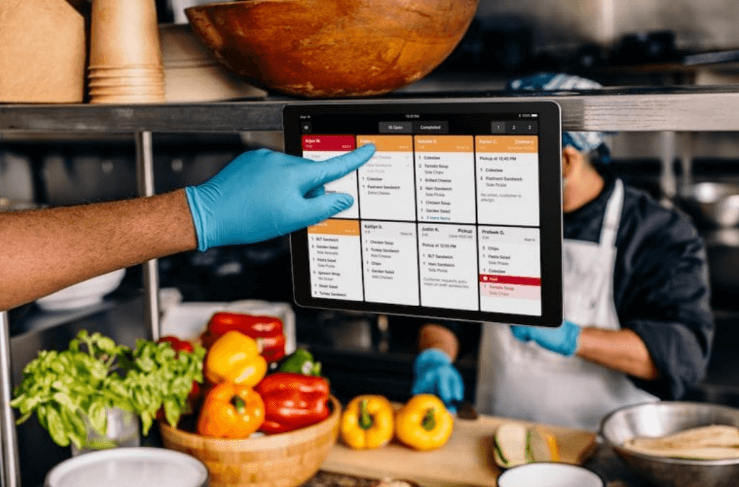 restaurant employee using a kitchen display system